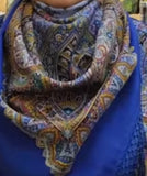 Colorful patterned scarf on a person wearing a blue garment