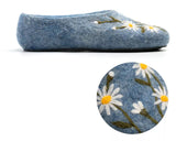 Slippers made from blue natural sheep wool with chamomile flowers embroidery on a white surface.