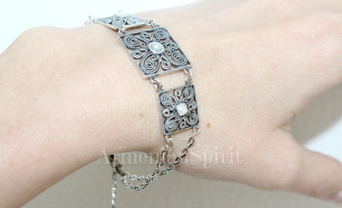 A sterling silver 925 filigree bracelet with a lab white pearl displayed on a person's wrist. The best Armenian silver store offers stunning ethnic designs.
Jewelry directly from Armenia means true quality.
Looking for reliable silver gifts is easy with Armenian Spirit.
This is the top online silver seller Armenian Spirit store.
Find out where to buy silver jewelry after closing Armenian stores on Etsy.

