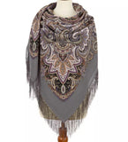 Paisley patterned scarf with fringes on a mannequin against a white background