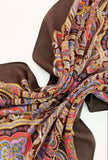 Colorful patterned woolen shawl with a brown background
