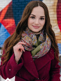 Woman wearing a colorful scarf and red coat in front of a colorful mural. Soft, non-prickly, and elegant, it is ideal for stylish everyday use.