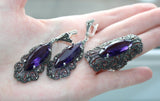 Armenian handmade jewelry set made from sterling silver 925, marcasite and including long earrings and ring with deep purple topaz  gemstone in Royal old vintage style on a hand with Armenian Spirit brand tile.
