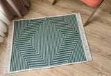 Green and white geometric patterned rug on a wooden floor
