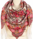Close-up detail of a manequin showcasing a luxurious Slavic-style merino wool palantine. The oversized shawl features detailed botanical and paisley scrollwork over a cream-colored base, with a highly textured, flowing white fringe hanging across the lower hem.