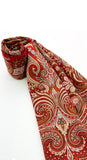 An oversized winter palantine made of soft merino wool, featuring traditional folk ornaments in red, brown, and white with a heavy fringed border.