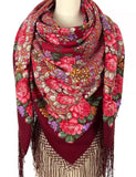 Colorful floral patterned wrapping scarf with silky fringes made of merino wool. Burgundy red tones with red and pink vintage roses create a Slavic accessory.