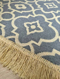 Close-up of a blue and beige patterned rug with fringe