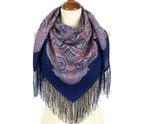 Navy blue scarf with Indian mandala and paisley pattern and fringes on a mannequin against a white background