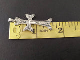 Armenian handmade cross made of sterling silver with traditional Armenian ornaments and eight points on a yellow ruler showing its length 1.5 inch.