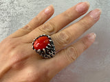 Introducing our high quality, one of a kind artisan jewelry set. Made with sterling silver 925 stamping, this large ring and earrings feature a bright orange almost red agate natural gem. Perfect for vintage lovers and gift giving. Buy retro jewelry. ring with gothic pattern and oval natural gemstone.

