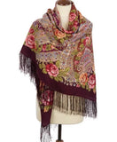 Floral patterned scarf with fringes on a mannequin against a white background