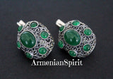 A pair of dome-shaped silver earrings with green quartz stones, handcrafted with intricate details, displayed against a black background with the text 'ArmenianSpirit'.