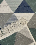 Geometric patterned rug with triangles and tassels