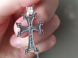 Armenian eight pointed traditional  cross with Echmiadzin tile on the reverse side in a woman hand.