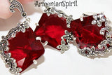 Red gemstone earrings with silver intricate designs on a white background, branded 'ArmenianSpirit'.