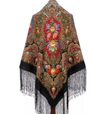 Woolen shawl with retro floral patterns and fringes on a white background. This classy black shawl combines soft merino wool with large floral peony patterns. A woman wearing it looks graceful, with black fringe adding a clean, elegant finish.
