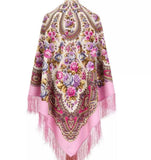 Colorful floral and paisley patterned oversized merino like cashmere woolen shawl with pink border and silky long fringe. The scarf is made of natural merino wool.