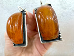 Expertly crafted from genuine honey amber with a stunning orange tint, our handmade Armenian jewelry is the perfect addition to any collection. Its large rectangle shape adds a touch of bold elegance to any outfit. Made of 925 sterling silver for lasting durability.
