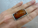 Expertly crafted by Armenian artisans, this sterling silver honey amber ring showcases a large, rectangular orange stone. Made with high quality materials, this exquisite piece of jewelry will add a touch of elegance and sophistication to any outfit. A must-have for any jewelry collection. You can buy this ring on our website and on ebay Armenian Spirit store.
