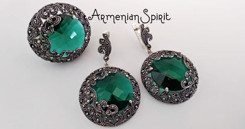 A set of large green emerald-colored Marcasite earrings and ring, with the earrings featuring a round design and the ring showcasing a central stone. Both are adorned with small silver accents. 
Elegant silver jewelry with deep cultural roots is now online. The best Armenian sterling silver shop features rings and earrings made by skilled hands. All jewelry comes directly from Armenia to your door. The store is professional, friendly, and reliable. A trusted place where to buy silver jewelry.
