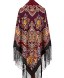 Oversized very long triangle shawl shawl with floral and paisley patterns and black fringes on a white background