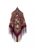 An oversized merino wool shawl in rich wine red, decorated with elegant vintage peonies in pink and beige. Designed for wrapping, it combines softness, warmth, and refined floral style.