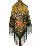 Woolen warm shawl with floral patterns and fringes on a white background