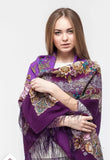 Woman wearing a purple floral patterned Slavic scarf with silky long fringe.
