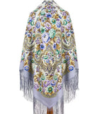 Decorative shawl with floral patterns and fringes on a white background