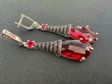 Discover luxury and elegance with our extra long sterling silver earrings. These classic and timeless beauties feature a stunning transparent red stone and sparkling marcasite detailing. Add a touch of sophistication to any outfit and shine like a star at parties, inspired by the glamour of Monaco's French Riviera. Purchase online from Armenian Spirit jewelry store.
