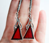 A sterling silver 925 set including very long earrings and a ring, featuring burnt orange faux stone.