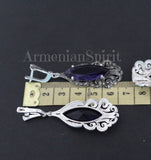 Long marcasite earrings with purple stone near a yellow ruler showing the earrings length 6 cm.