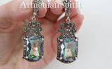 Long Earrings in Royal rich style with Herbal ornament and mystic topaz faceted gemstone in a women`s hand with Armenian Spirit brand name.