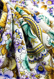 Close-up of a colorful floral and paisley patterned fabric.