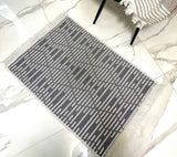 Gray patterned rug on a marble floor