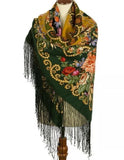 Colorful vintage floral and paisley patterned woolen Slavic scarf cashmere quality with fringes on a mannequin against a white background
