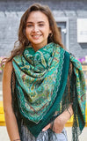 A woman wearing a green shawl with yellow patterns looks bright and elegant. The rich colors stand out beautifully and add warmth and style.