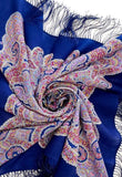 Blue and pink paisley patterned blue woolen scarf with decorative elements on a white background