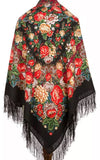 An extra-large wrapping shawl showcasing traditional Slavic peony flowers on a deep black background. The red and yellow vintage floral pattern pairs beautifully with soft merino wool and an elegant silky fringe.