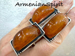 Our high quality jewelry is crafted with sterling silver 925 and features beautiful honey amber large rectangle earrings and a matching ring. Handmade by Armenian artisans, this jewelry exudes elegance and sophistication. Elevate your look with these stunning and unique pieces.
