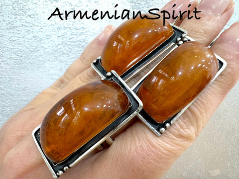 Our high quality jewelry is crafted with sterling silver 925 and features beautiful honey amber large rectangle earrings and a matching ring. Handmade by Armenian artisans, this jewelry exudes elegance and sophistication. Elevate your look with these stunning and unique pieces.
