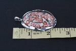 Buy very large pendant 2 or 2.5 inch length natural jasper with animal print like leopard.