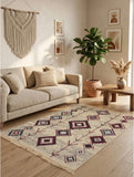 A bohemian-style area Armenian rug with a geometric tribal pattern in beige, navy, and red, styled on a light wood floor in a modern living room setting.