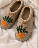 Woolen slippers with orange rowanberry.