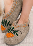 Woolen slippers made in clogs design with orange berries.