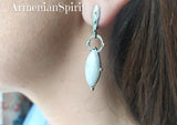 Elevate your style with our high-quality sterling silver earrings. These long gold plated beauties feature a stunning white moonstone with a blue tint, all inspired by the Armenian Spirit. Embrace a unique and contemporary look with these gemstone-adorned earrings. Only available at our online shop. Purchase online from the best on Etsy and eBay - we're on multiple platforms for your convenience. Elevate your style with us!