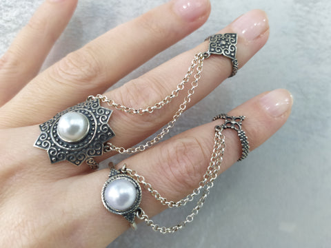 Elevate your style with our high quality, sterling silver 925 stamped jewelry. Inspired by Western Armenia's traditional taraz outfits, our double rings feature intricate Armenian designs and beautiful white pearls. Complete your ethnic boho look with these joyful, ornamental pieces. Buy now with affordable prices ethno rings.

