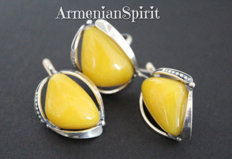 Very delicate feminine jewelry with Baltic amber gemstone made of sterling silver 925 and ornament. The earrings and ring have intersting triangle shae with polished smooth yellow amber gem.