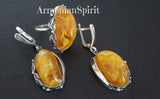 Stunning jewelry earrings and ring honey amber oval gemstones. Handcrafted artisan design jewelry with amber gemstones and unique ornament around jewelry. One of a kind jewelry from Armenian artisans and jewelry makers.